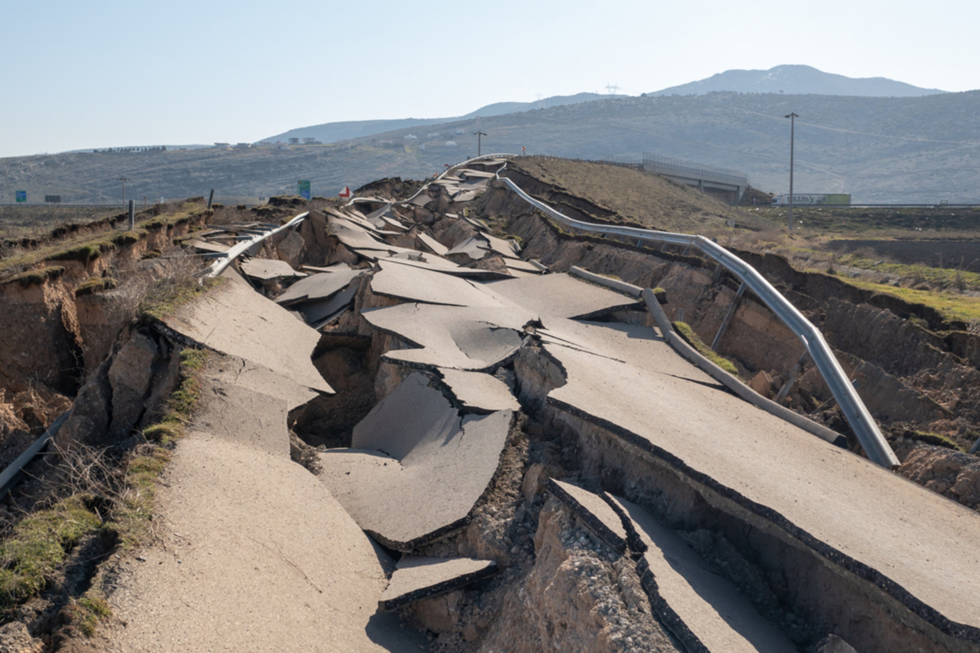 Photograph showing a road severely damaged by an earthquake